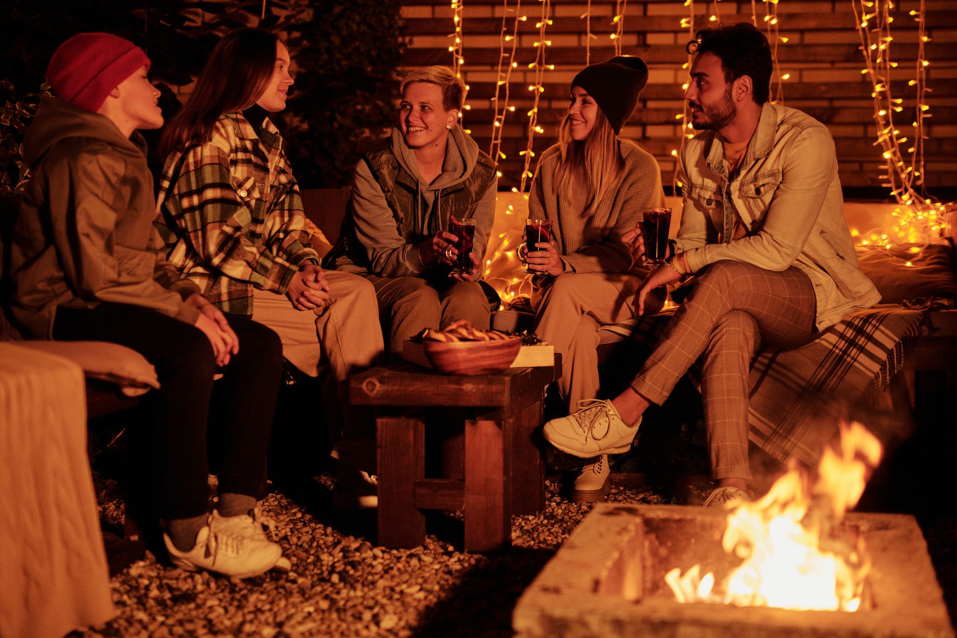 Friends around a fire pit at night